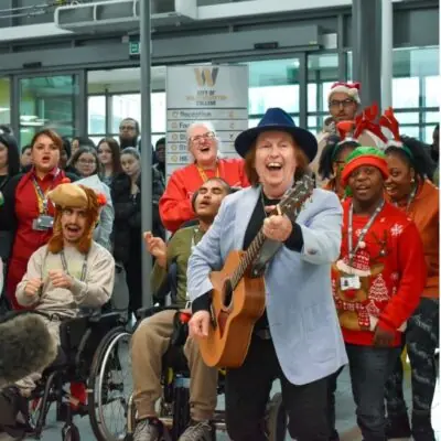 SLADE GUITARIST DAVE HILL SPREADS FESTIVE CHEER AT STUDENTS' CHRISTMAS PARTY